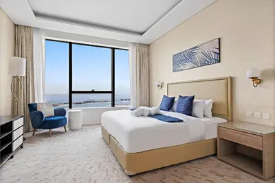 a bedroom with a bed and a large window at Stonetree - Full Sea View - Luxury Tower with 5 Star Facilities in Dubai