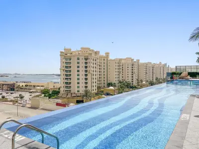 a large swimming pool on the side of a building at Stonetree - Full Sea View - Luxury Tower with 5 Star Facilities in Dubai