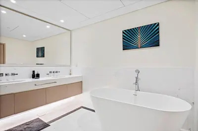 a white bathroom with a tub and a sink at Stonetree - Full Sea View - Luxury Tower with 5 Star Facilities in Dubai
