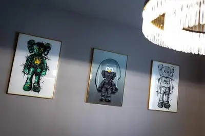 a group of framed pictures of teddy bears on a wall at Goldbest La Mer - Luxury 1 bdr Apartment with Beachfront Pool in Dubai