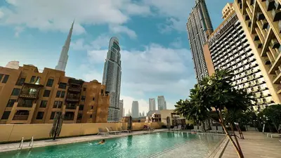 a swimming pool in a city with tall buildings at SmartStay at Burj Royale - Unique Downtown Dubai City Views - Brand New Luxury Apartments in Dubai