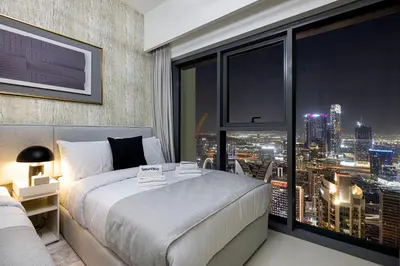 a bedroom with a bed and a large window at SmartStay at Burj Royale - Unique Downtown Dubai City Views - Brand New Luxury Apartments in Dubai