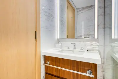 a bathroom with a sink and a mirror at RH- Elevated Living, Modern 1BR Oasis at RP Heights walk away to Dubai Mall in Dubai