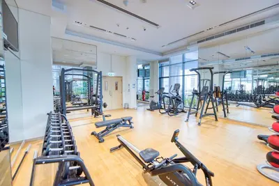 a gym with several treadmills and exercise bikes at RH- Elevated Living, Modern 1BR Oasis at RP Heights walk away to Dubai Mall in Dubai