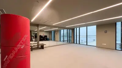 a large room with a red pillar in a building at Bright 2BR with Pool & Creek Views in Dubai