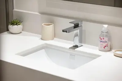 a sink with a faucet in a bathroom at Bright 2BR with Pool & Creek Views in Dubai