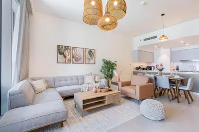 a living room with a couch and a table at Luxury 3BHK, Burj Khalifa & Dancing fountain view in Dubai