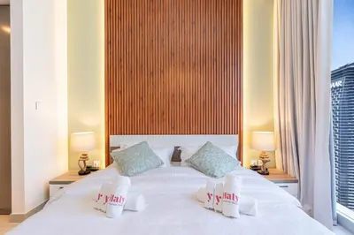 a bedroom with a white bed with two pillows at Luxury 3BHK, Burj Khalifa & Dancing fountain view in Dubai