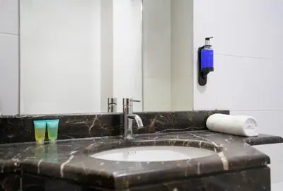 a bathroom counter with a sink and a mirror at RH - Spacious studio, near Dubai Mall, Downtown in Dubai