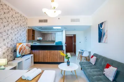 a living room with a couch and a table at RH - Spacious studio, near Dubai Mall, Downtown in Dubai