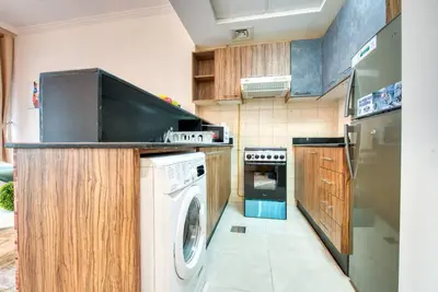 a kitchen with a washing machine and a washer at RH - Spacious studio, near Dubai Mall, Downtown in Dubai