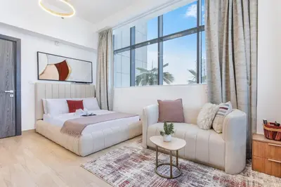 a living room with a bed and a couch at Holiday Studio in JVC 2408, Dubai in Dubai