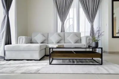 a living room with a white couch and a coffee table at Sleeps 8 Private Cinema World Island Views in Dubai