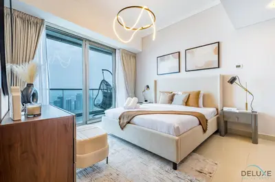 a bedroom with a large bed and a large window at Luxury 3BR in Ocean Heights, Dubai Marina by Deluxe Holiday Homes in Dubai