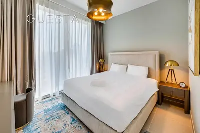 a bedroom with a bed and a large window at Forte Tower - Dubai Fountain View, Downtown Dubai in Dubai