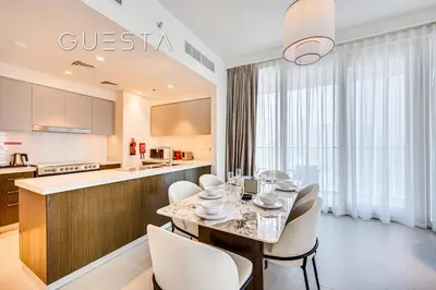 a kitchen and dining room with a table and chairs at Forte Tower - Dubai Fountain View, Downtown Dubai in Dubai
