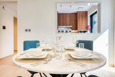 a white table with glasses and napkins on it at RH - Beautiful & Spacious furnished 01 BR, Walk away from Dubai Mall in Dubai