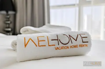 a white towel with the word welcome written on it at WelHome - Charming Breathtaking 1BR Apt. In Damac Hills in Dubai