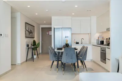 a kitchen and dining room with a table and chairs at FULL Burj Khalifa view 2BR with Dubai Mall connection in Downtown in Dubai