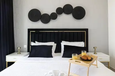 a bedroom with a bed with a tray of food on it at FULL Burj Khalifa view 2BR with Dubai Mall connection in Downtown in Dubai