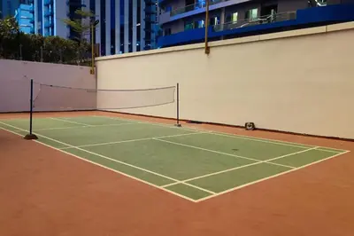 a tennis court with a net on top of it at RH - Spacious chic apartment, Next to Dubai Mall in Dubai