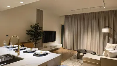 a living room with a couch and a table at quiet green 1 bedroom for your rest in Dubai