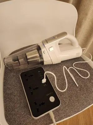 a hair dryer sitting on top of a table with a phone at quiet green 1 bedroom for your rest in Dubai