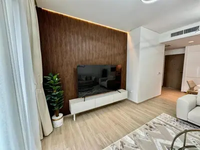 a living room with a fireplace in the wall at High Floor, 1 Bedroom in Palace Residence in Dubai