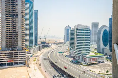 a highway in a city with many tall buildings at RH - Best location, 01 BR Spacious, walk to burj in Dubai