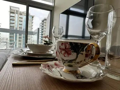 a table with a tea cup and glasses on it at Dubai 7 in Dubai