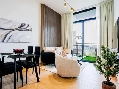 a living room with a couch and a table at Stylish JVC 1 Bedroom Sanctuary in Dubai