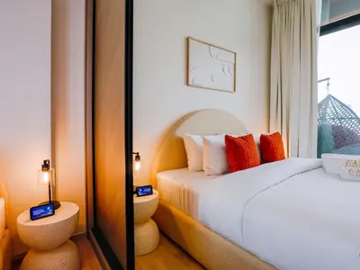 a bedroom with a bed and a mirror at Stylish JVC 1 Bedroom Sanctuary in Dubai