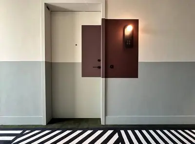 a hallway with a door with a light on it at Houzzze #4 DesignStudio Burj Khalifa view in Dubai