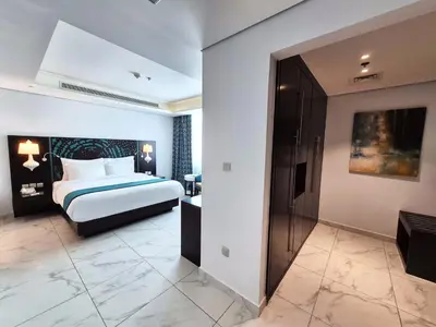 a hotel room with a bed and a bathroom at Signature Hotel Al Barsha in Dubai