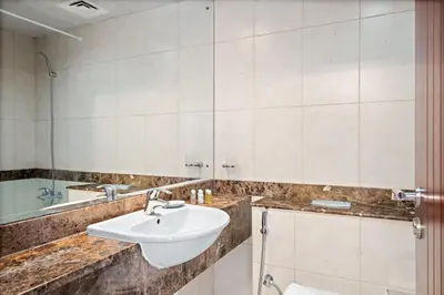 a bathroom with a sink and a mirror at Silkhaus High Floor 1 BDR with Metro Nearby in Dubai
