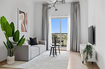 a living room with a couch and a table at Silkhaus High Floor 1 BDR with Metro Nearby in Dubai