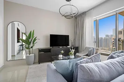 a living room with a couch and a tv at Silkhaus Modern 1 BDR With Easy Access to Downtown in Dubai