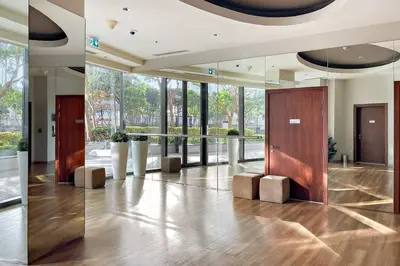 a lobby with a hallway with wooden doors and windows at Luxury 1BR Skyline & Sea Views Walk to Dubai Mall & Burj Khalifa in Dubai