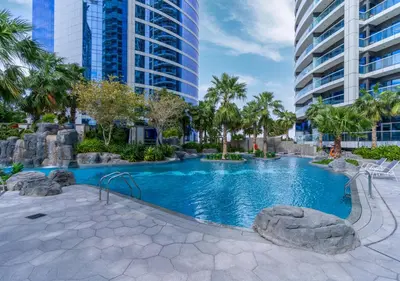a swimming pool in a city with tall buildings at Savis Homes - Damac Paramount Tower A 1BR Ultimate Luxury and Glam Escape in Dubai