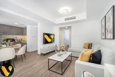 a white living room with a couch and a table at Vogue Springs Emirates Living near The Springs Souk, JBR, Marina, Mall of the Emirates, Spacious Villa with Garden and access to Lake and all Amenities in the Community in Dubai