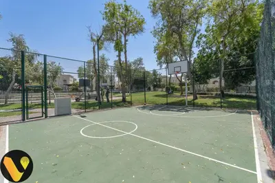 a basketball court with a basketball hoop at Vogue Springs Emirates Living near The Springs Souk, JBR, Marina, Mall of the Emirates, Spacious Villa with Garden and access to Lake and all Amenities in the Community in Dubai