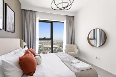 a bedroom with a large bed and a mirror at Silkhaus High Floor Luxury 1BDR in New Tower in Dubai