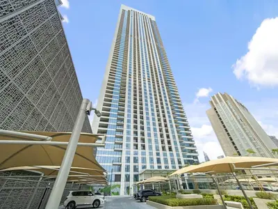 a tall building with a car parked in front of it at Silkhaus High Floor Luxury 1BDR in New Tower in Dubai
