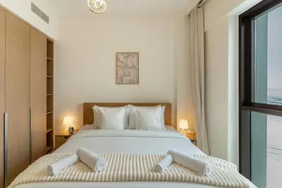 a bedroom with a large bed and a window at Spacious 1-Bedroom in Summer, Lagoon Access Feature - Allsopp&Allsopp in Dubai