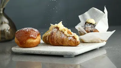 two pastries sitting on a plate on a table at InterContinental Residences Dubai Business Bay by IHG in Dubai
