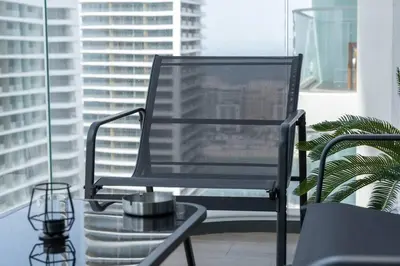 a black chair in a room with a window at Czechin * Brand New * BeachFront * Palm View * High Floor in Dubai