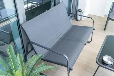 a black chair in a room with a plant at Czechin * Brand New * BeachFront * Palm View * High Floor in Dubai