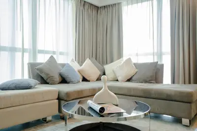 a living room with a couch and a glass table at Luxe 2BR Haven with Spectacular Burj Khalifa & Dubai Frame Views By ĀYA Boutique in Dubai