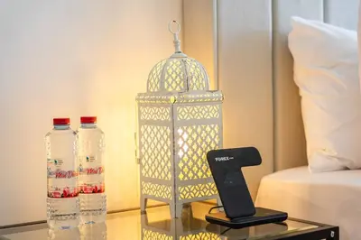 a bird cage sitting on a table next to a bed at New Listing * Pool & Marina Skyline View * TOP Amenities in Dubai