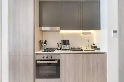 a kitchen with a stove and a sink at New Listing * Pool & Marina Skyline View * TOP Amenities in Dubai